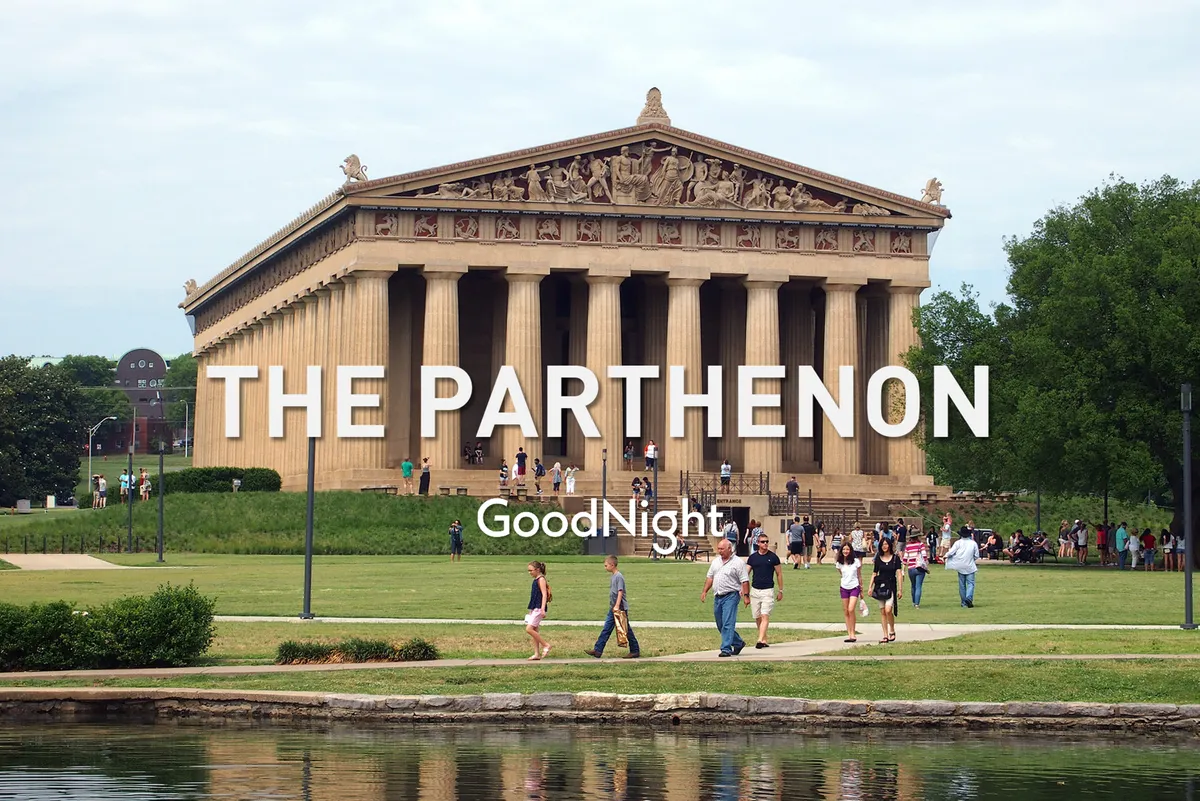 The Parthenon stands majestically amidst a lush green park, with visitors walking around and engaging in leisure activities. The scene evokes a sense of history and culture within an outdoor, urban setting.