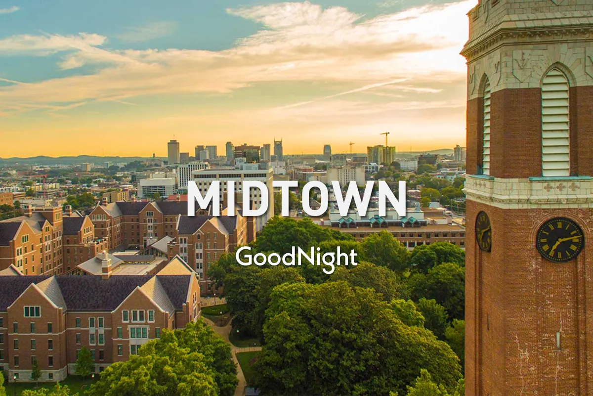 This image captures the city skyline with historic buildings, a clock tower, and lush greenery in the foreground. The scene evokes the experience of strolling in a nearby park and enjoying the outdoors, suggesting proximity to attractions like Centennial Park.